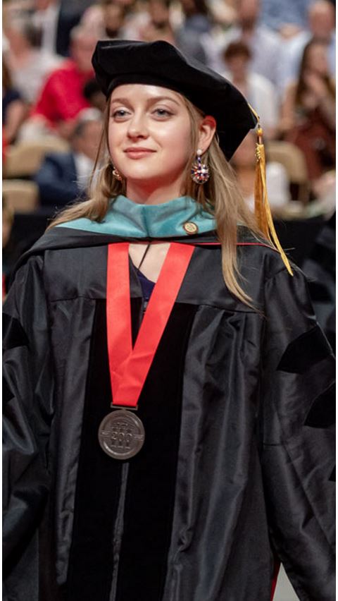 Female student in graduation cap and robe. 