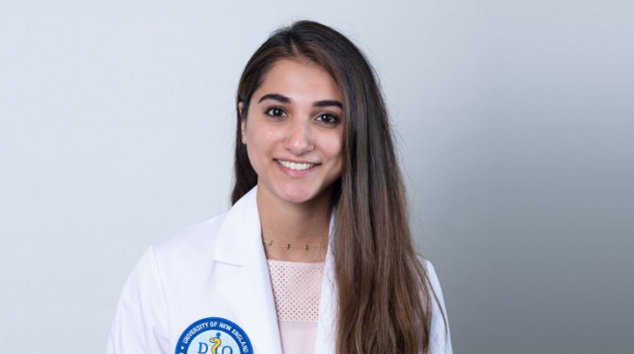Close up photo of Kinza Hussain, alum of the online Healthcare Management MBA at MCPHS wearing a labcoat