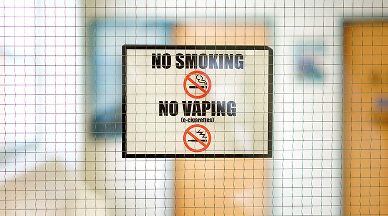A sign on a door that says no smoking.