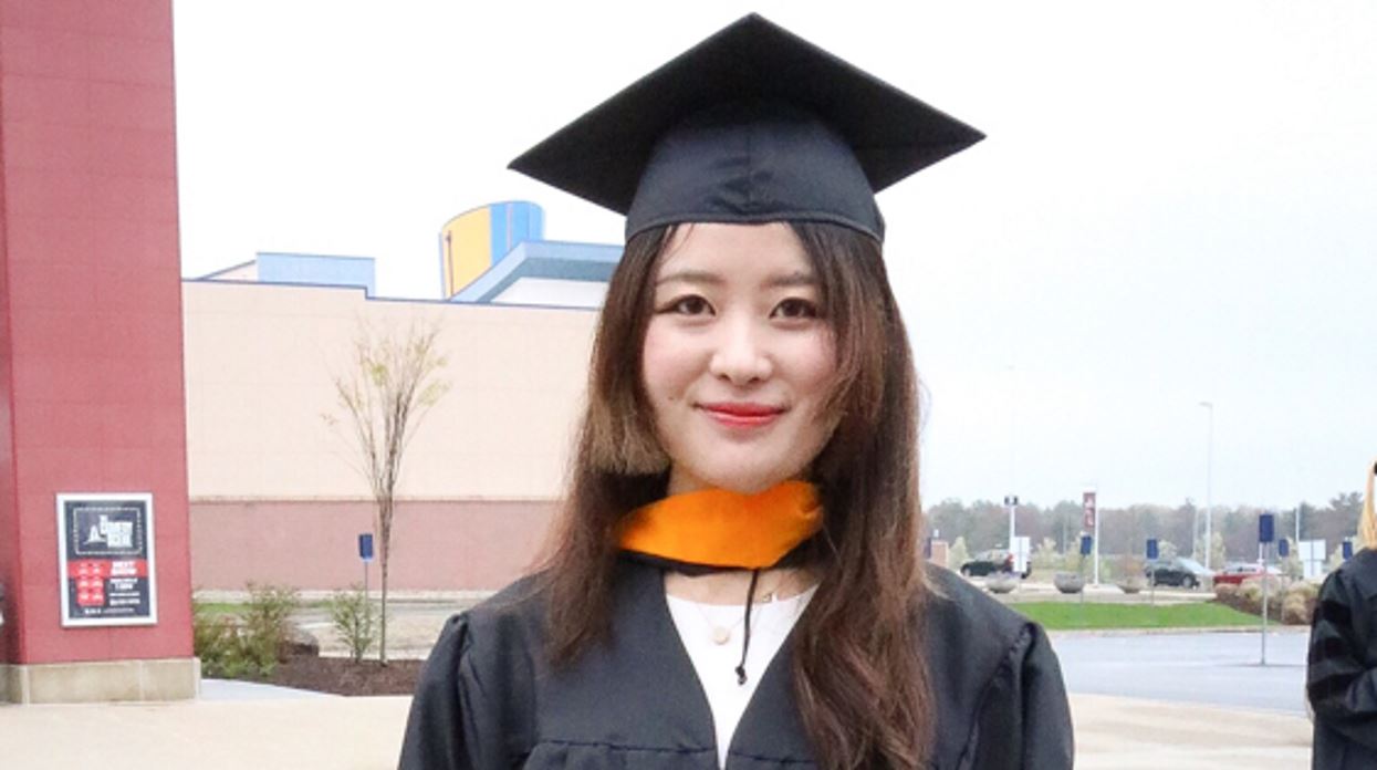 Photo of Zheying Li in a graduation cap and gown