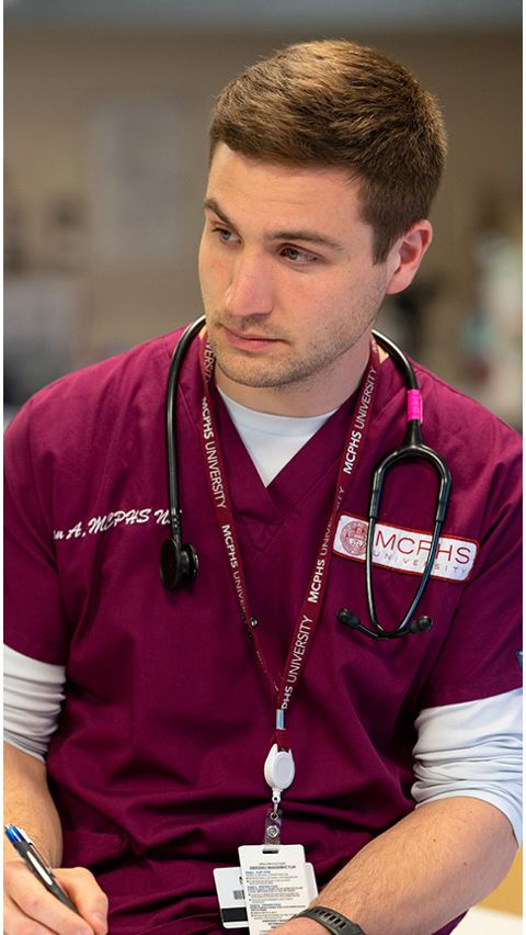 Nursing student in scrubs.