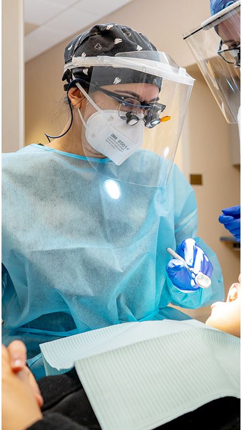 Female Dental Hygiene student in scrubs and mask. 