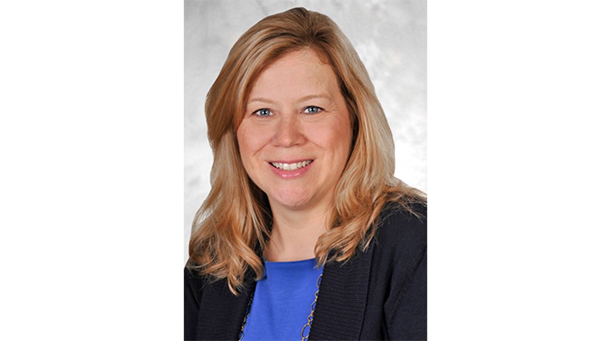 Close up photo of Carol Anthony in black blazer and blue shirt