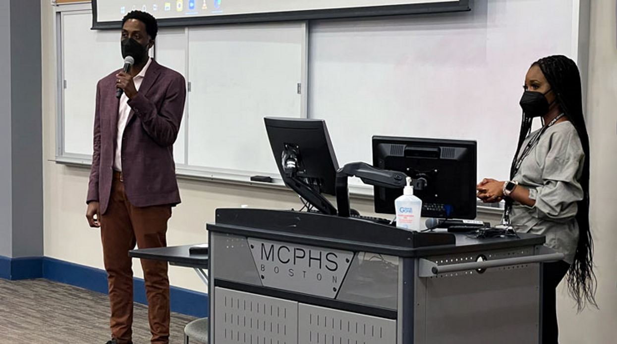 Dr. Nii Addy speaking in a classroom at MCPHS.