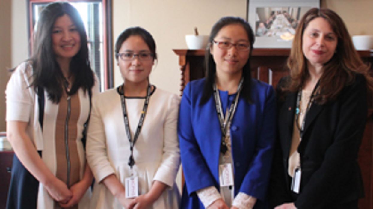 Two oncology pharmacists from China post for a photo with Caroline Zeind, Provost of MCPHS