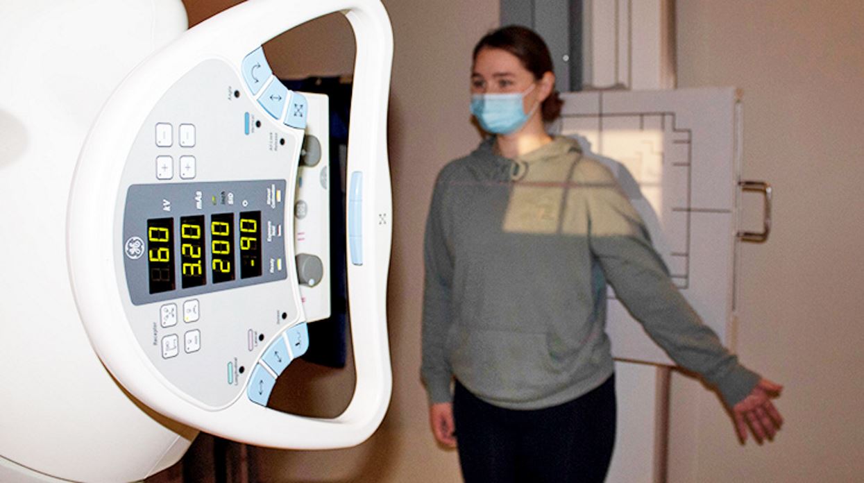 Photo of student by brand new xray machine
