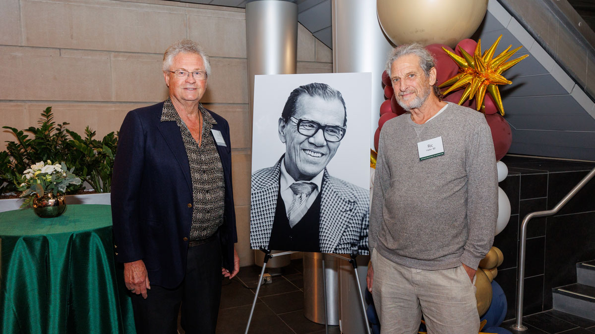 Jim Martin and Ric Hahn pose next to a portrait of Dr. So.