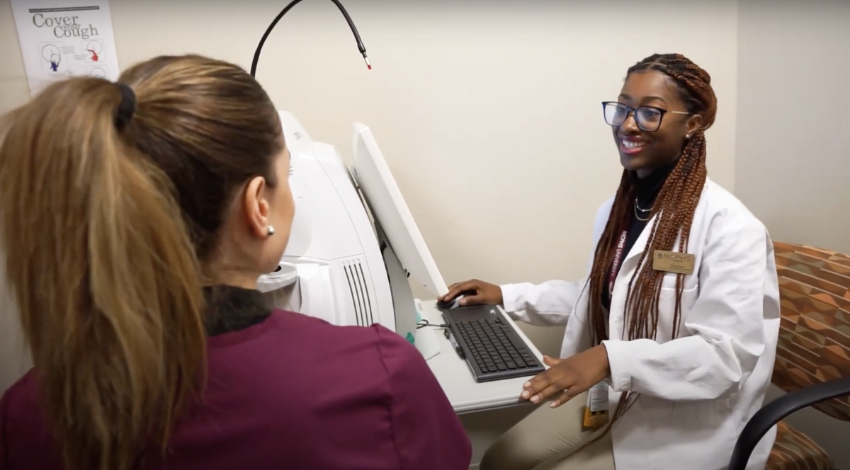 Optometry student helping a patient
