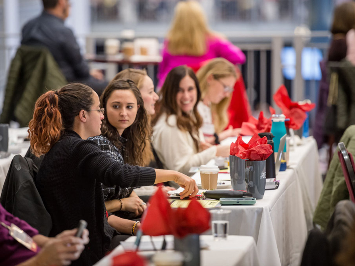Reed attendees sitting at event table. 