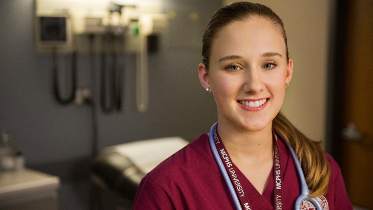 Smiling female student in scrubs. 