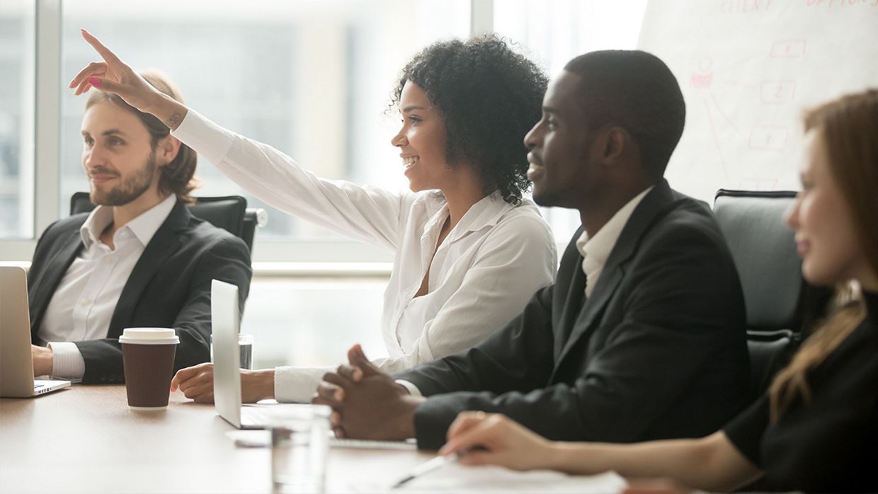 Group of people in corporate attire in a discussion. 